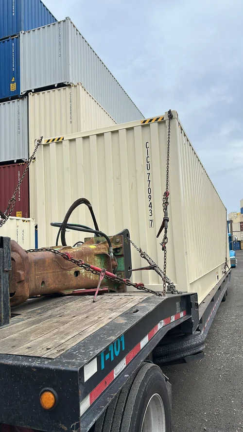 40ft high cube full open side shipping container being transported on a flatbed truck