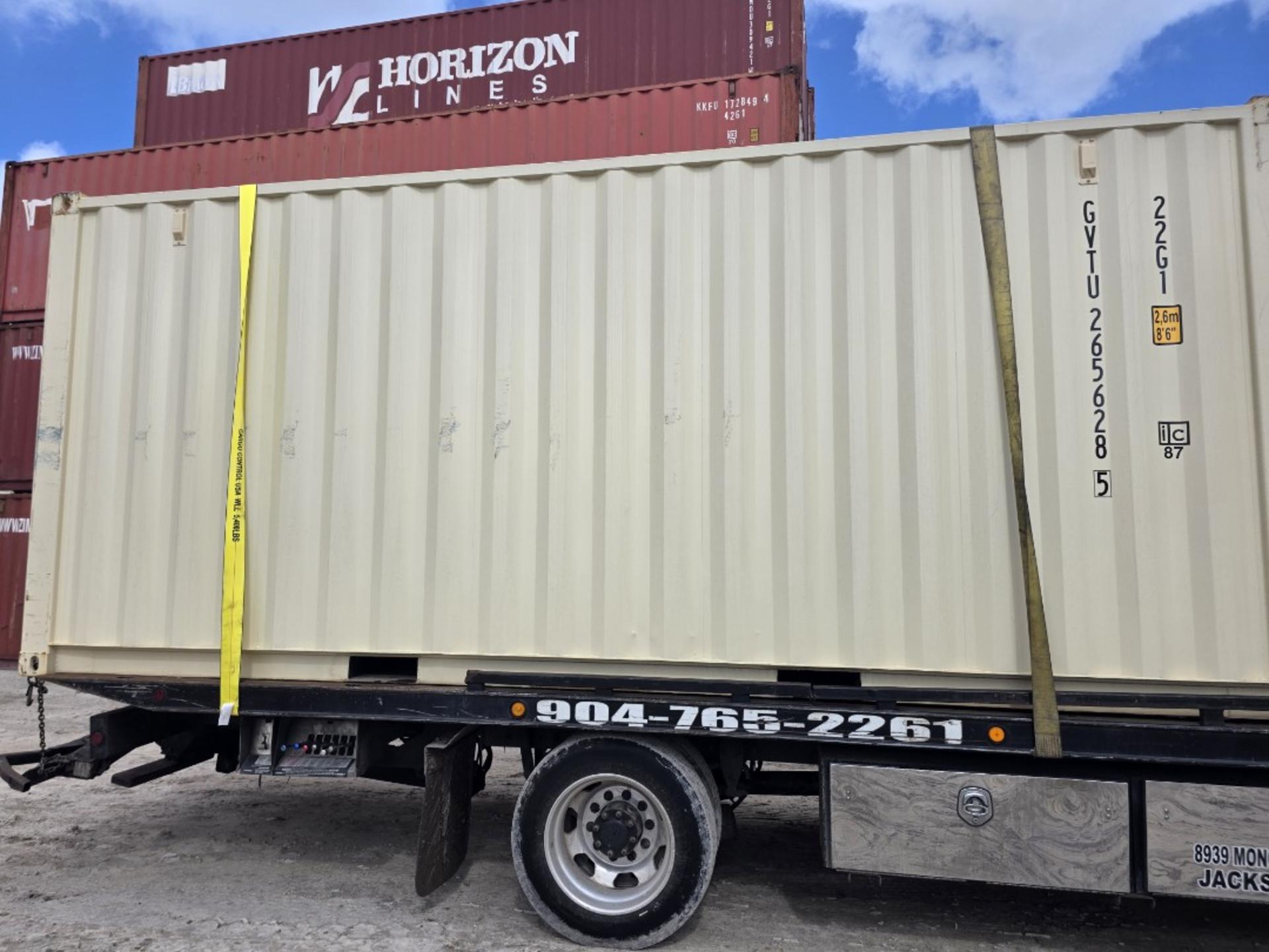 Side view of beige 20ft one trip container secured on chassis trailer