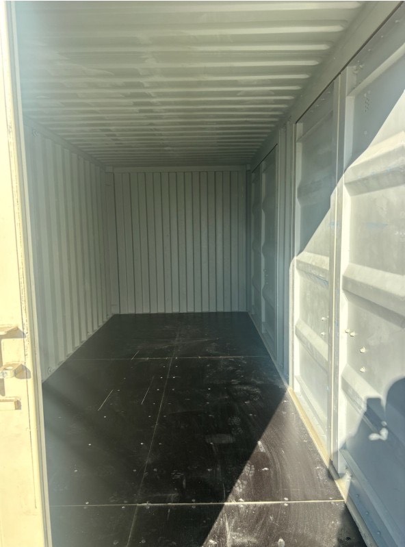 Interior view of a new 20ft open side shipping container with clean plywood floor