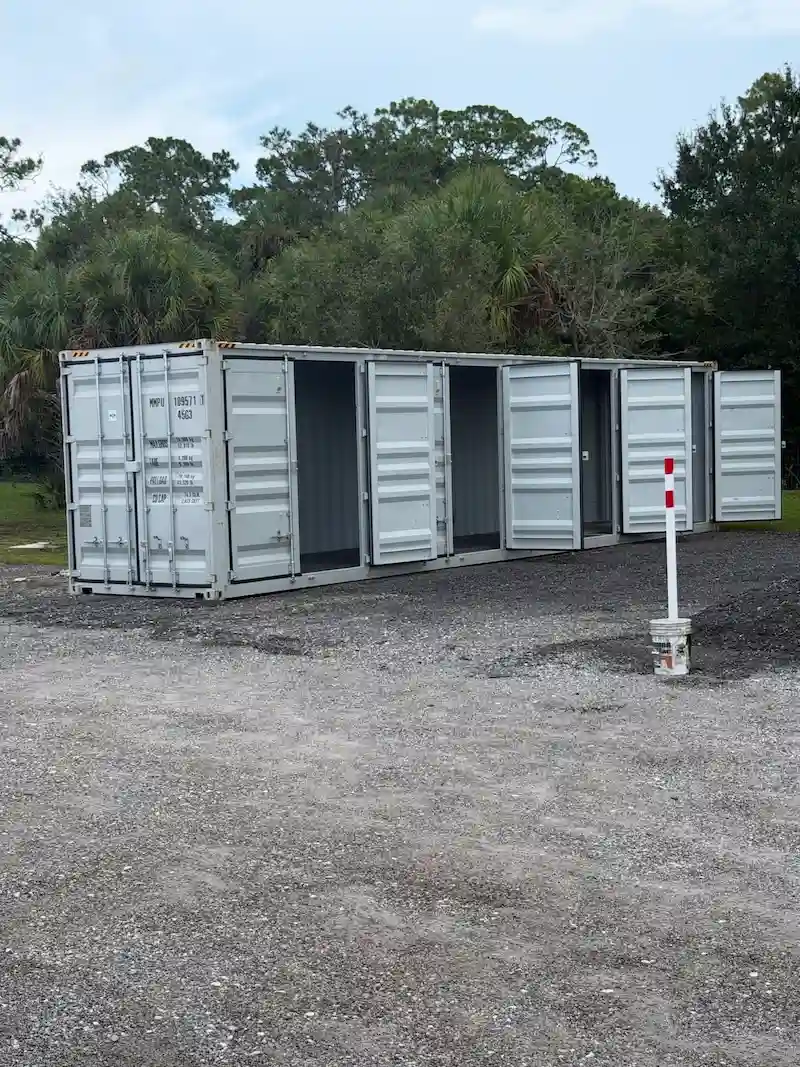New 40ft high cube open side container with all 4 side doors open placed on gravel in Vero Beach Florida